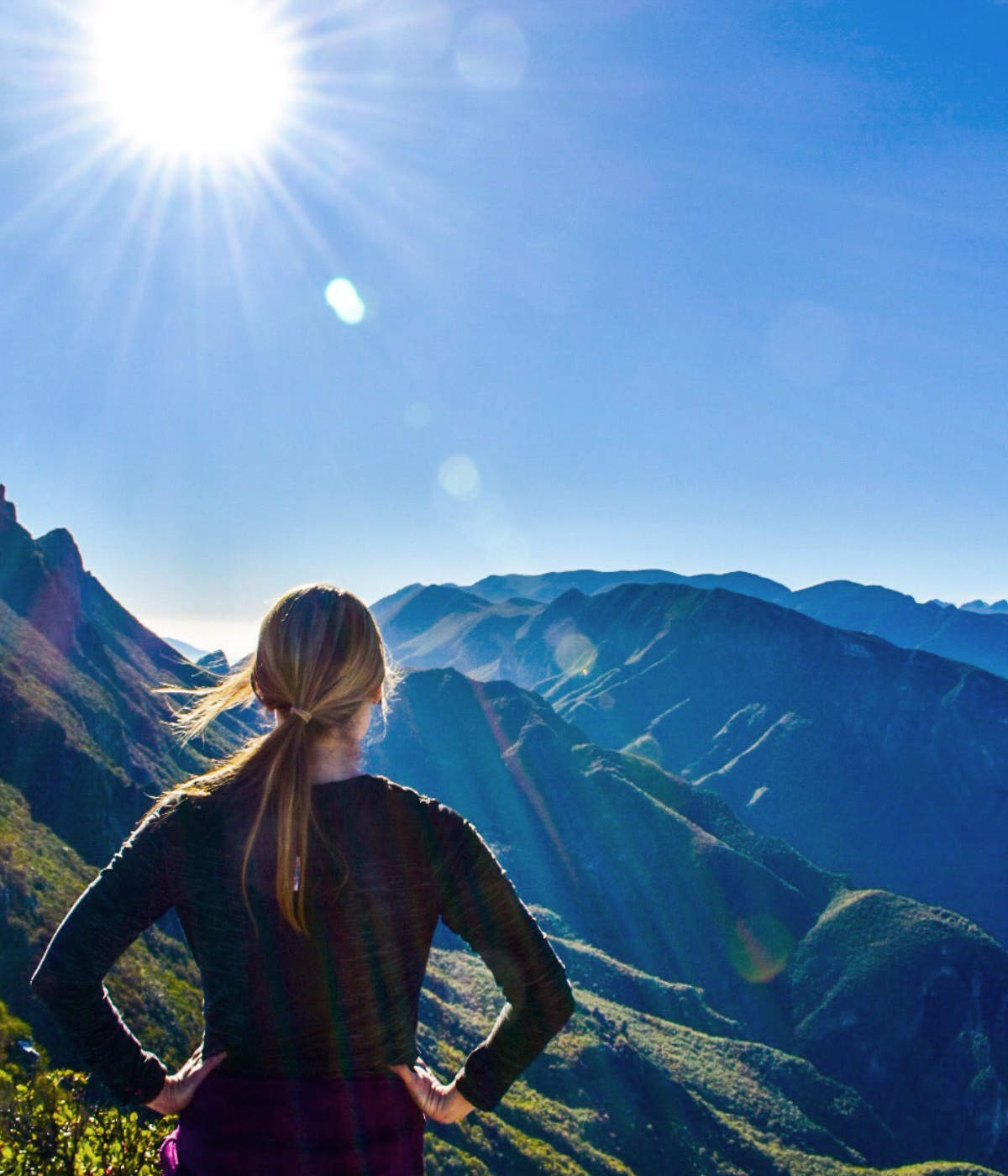 Woman at Mountain Top looking at horizon