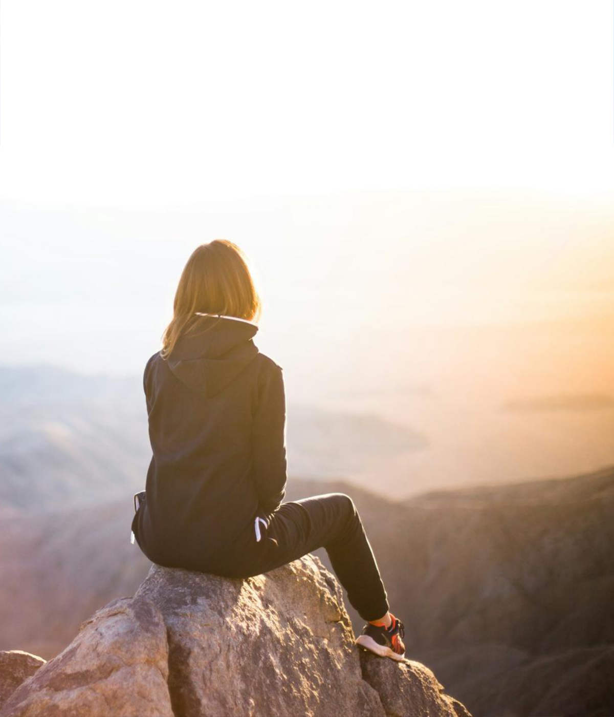 Woman at Mountain Top looking at horizon